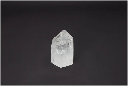Lemurian Quartz Obelisk on black background, known for energetic and spiritual properties, linked to chakras and zodiac signs.