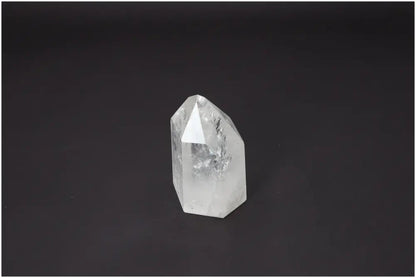 Lemurian Quartz Obelisk crystal on black background, enhances chakra energy, spiritual and zodiac alignment with unique properties.