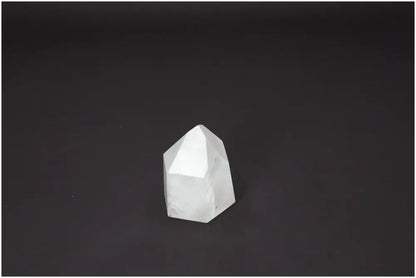 Lemurian Quartz Obelisk crystal on dark background, showcasing its spiritual and healing properties.