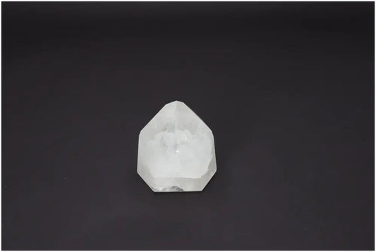 Lemurian Quartz Obelisk on dark background showcasing its unique crystal clarity and spiritual energy properties.