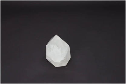 Lemurian Quartz Obelisk crystal against black background, showcasing its unique properties and association with chakras.