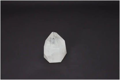Lemurian Quartz Obelisk with spiritual and energetic properties on a dark background.