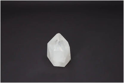 Polished Lemurian Quartz Obelisk on a dark background, ideal for chakra healing and spiritual enhancement.