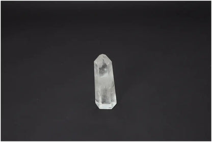 Lemurian Quartz Obelisk on black background, showcasing unique energetic properties linked to chakras and zodiac signs.