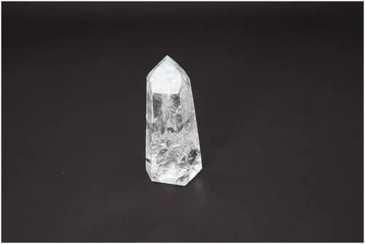 Lemurian Quartz Obelisk for chakra alignment and spiritual enhancement on dark background