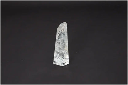 Lemurian Quartz Obelisk with unique energy properties, aligned with chakras and zodiac signs, against a dark background.