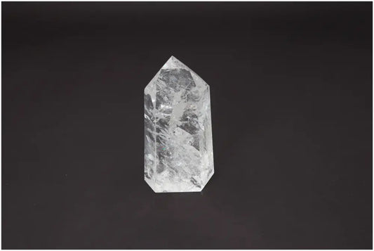 Lemurian Quartz Obelisk with unique energetic properties for chakra and zodiac alignment on a dark background.