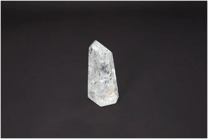 Lemurian Quartz Obelisk on black background, showcasing unique energetic and spiritual properties for chakra alignment.
