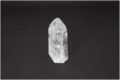 Lemurian Quartz Obelisk crystal on a dark background, showcasing its clear, multifaceted structure and spiritual energy properties.