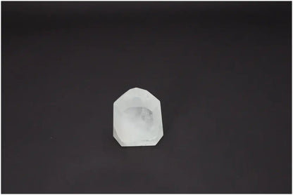 Lemurian Quartz Obelisk on a dark background, showcasing its unique properties and spiritual associations with chakras and zodiac signs.