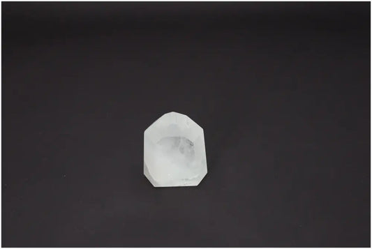 Lemurian Quartz Obelisk on a dark background, showcasing its unique properties and spiritual associations with chakras and zodiac signs.