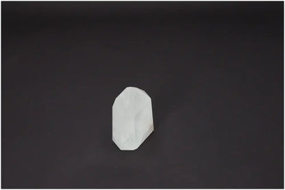Lemurian Quartz Obelisk on dark background, known for its chakra and zodiac energy properties, balancing body and soul.