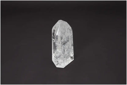 Lemurian Quartz Obelisk on a dark background, showcasing its clarity and unique properties for chakra and zodiac energy alignment.