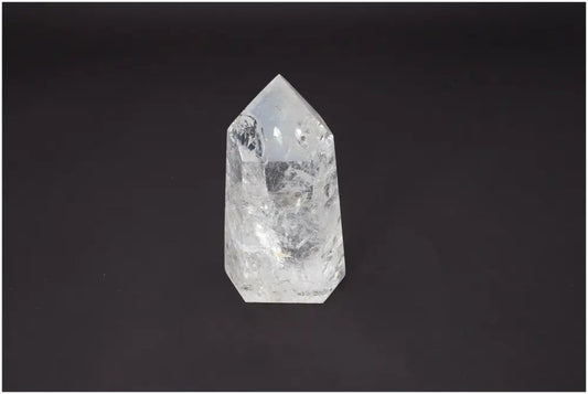 Lemurian Quartz Obelisk crystal for chakra healing and spiritual energy balance on a dark background.