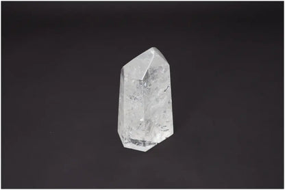 Lemurian Quartz Obelisk for chakra healing and energetic balance against black background.
