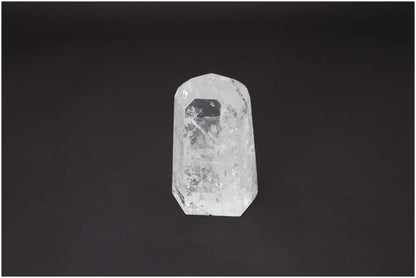 Lemurian Quartz Obelisk on black background, known for its unique properties affecting body and soul, linked to chakras and zodiac signs.