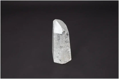 Lemurian Quartz Obelisk on black background, known for unique properties affecting body and soul, linked to chakras and zodiac signs.