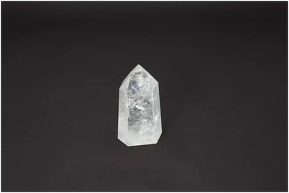Lemurian Quartz Obelisk against a black background, showcasing its unique properties related to chakras and zodiac signs.