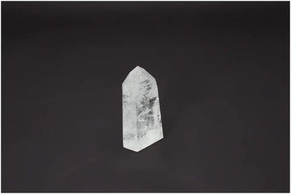 Lemurian Quartz Obelisk for chakra and zodiac alignment on a dark background.