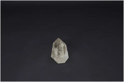 Lemurian Quartz Obelisk against dark background, showcasing unique crystal clarity and energy properties for chakra and zodiac alignment.