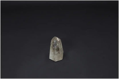 Lemurian Quartz Obelisk against a dark background, showcasing unique properties and spiritual connections with chakras and zodiac signs.