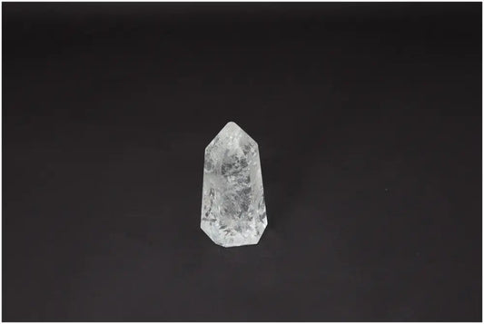 Lemurian Quartz Obelisk on dark background, showcasing its unique crystal structure and spiritual properties for chakra healing.