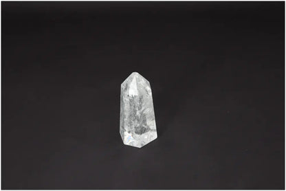 Lemurian Quartz Obelisk on dark background, showcasing unique crystal properties for chakra and zodiac energy alignment.