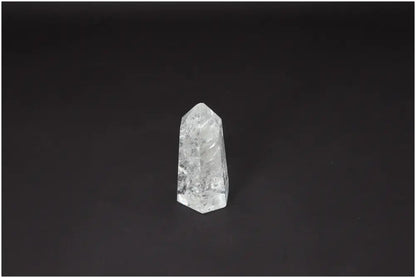 Lemurian Quartz Obelisk on black background, highlighting its spiritual properties and unique crystal structure.