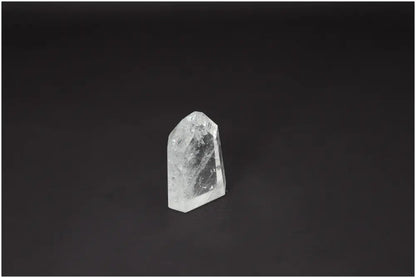 Lemurian Quartz Obelisk against dark background, highlighting unique spiritual properties for chakra balance and zodiac energy support.