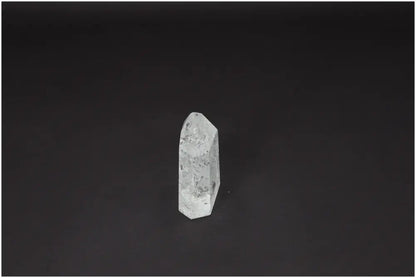 Lemurian Quartz Obelisk on dark background, showcasing unique energetic properties and spiritual significance for chakras and zodiac signs.