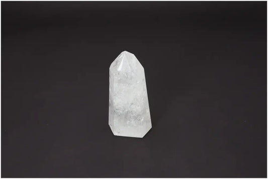 Lemurian Quartz Obelisk on a dark background, showcasing its clear, crystalline structure and spiritual energy properties.