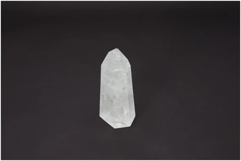 Lemurian Quartz Obelisk on dark background, showcasing its clear crystal structure and energetic properties.