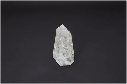 Lemurian Quartz Obelisk on dark background, known for its unique properties and connection to chakra and zodiac energies.