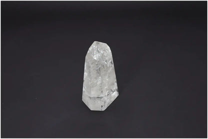 Lemurian Quartz Obelisk on dark background, emphasizing its unique structure and spiritual properties for chakra alignment.