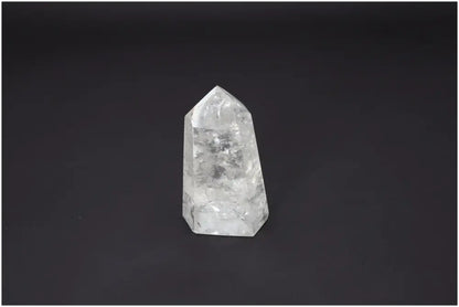 Lemurian Quartz Obelisk with unique properties for chakra alignment and spiritual enhancement on a dark background.