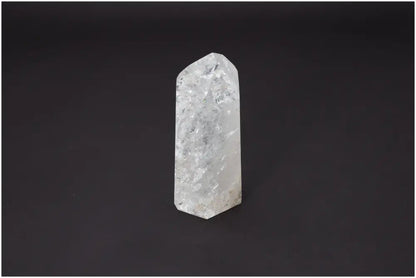 Lemurian Quartz Obelisk with unique properties enhancing chakras and zodiac alignment against a dark background.