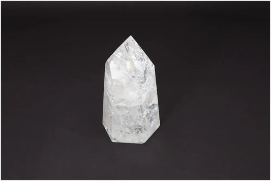 Lemurian Quartz Obelisk on black background showcasing its clear crystalline structure for chakra and zodiac energy alignment.