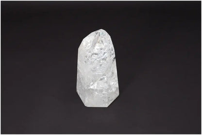 Lemurian Quartz Obelisk on dark background showcasing its clear crystalline structure for chakra and zodiac energy alignment.
