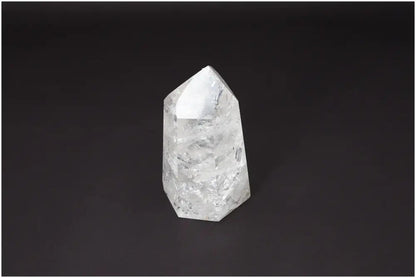 Lemurian Quartz Obelisk against a dark background, showcasing its unique crystalline structure and spiritual properties.