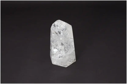 Lemurian Quartz Obelisk on dark background showcasing its unique clarity and properties for energetic and spiritual support.