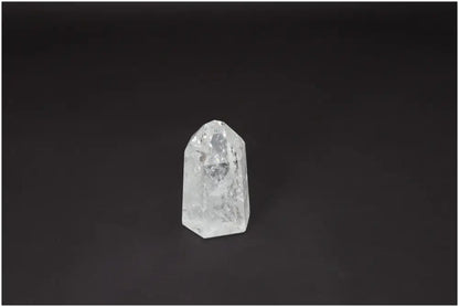 Lemurian Quartz Obelisk crystal on dark background, known for clarity and energy amplification, ethically sourced and naturally formed.