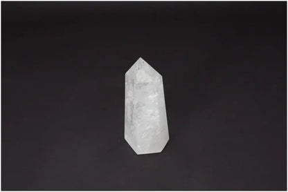 Lemurian Quartz Obelisk on black background, showcasing its clarity and natural formation, known as a "Master Healer" crystal for personal growth.