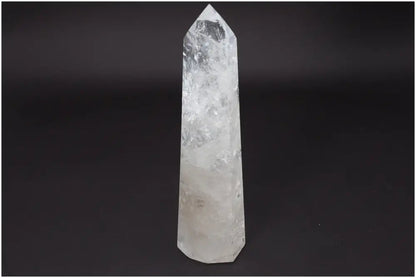 Lemurian Quartz Obelisk on black background, a clear crystal known for healing and energy amplification, hand-selected and ethically sourced.