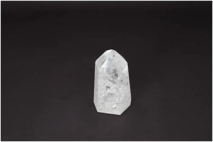 Lemurian Quartz Obelisk on black background, a clear crystal known as the 'Master Healer' that enhances clarity and balance.