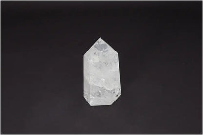 Lemurian Quartz Obelisk, ethically sourced clear quartz for clarity, balance, and personal growth, on a dark background.