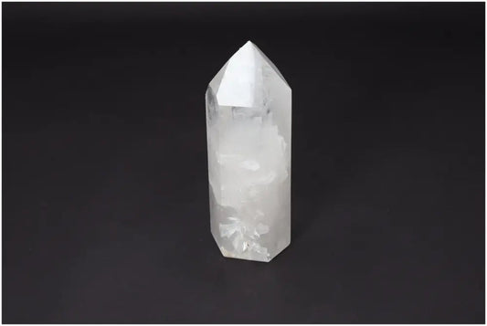Clear Lemurian Quartz obelisk on black background, known as a "Master Healer" for energy amplification, clarity, and personal growth.