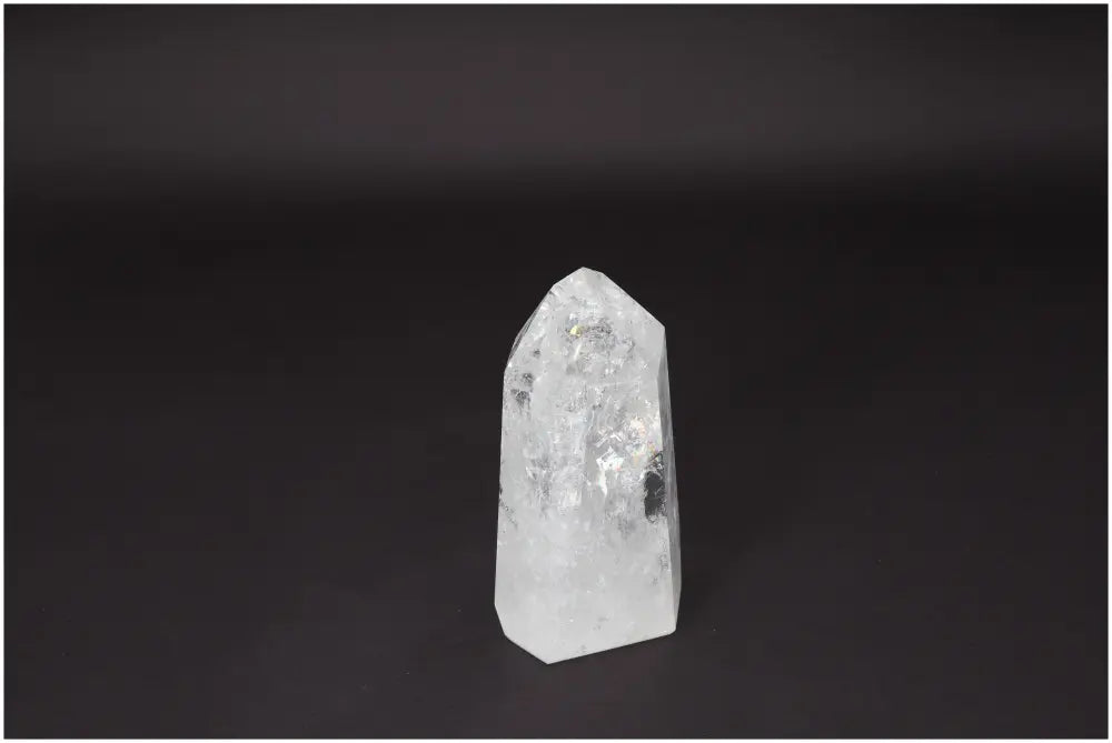 Lemurian Quartz Obelisk crystal on a dark background, a clear quartz known for clarity, balance, and amplifying energy and intentions.