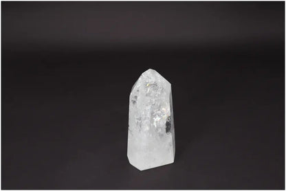 Lemurian Quartz Obelisk crystal on a dark background, a clear quartz known for clarity, balance, and amplifying energy and intentions.