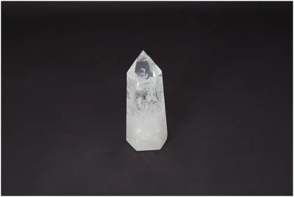 Lemurian Quartz Obelisk on black background, a clear healing crystal for clarity and balance, ethically sourced and naturally formed.