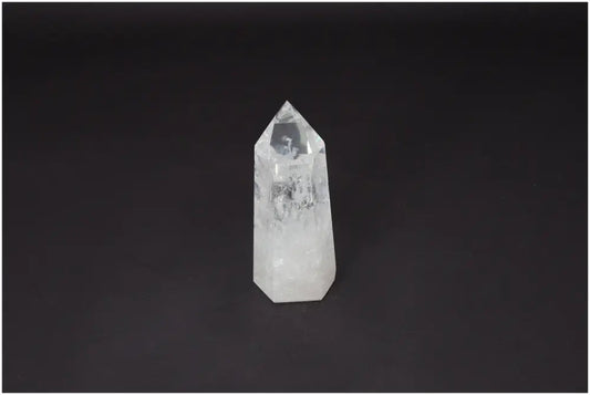 Lemurian Quartz Obelisk on black background, a clear healing crystal for clarity and balance, ethically sourced and naturally formed.